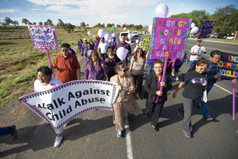 Marchers walk toward the Navajo nation Council Chamber in Window Rock Wednesday morning. The walkers, which included first lady Martha Shelly, holding the pink sign, were raising awareness of the Violence Against Family Act legislation. © 2011 Gallup Independent / Brian Leddy 